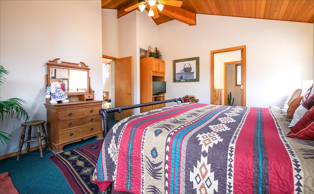 Master bedroom of family Sunriver home includes a king sized bed and private bathroom.