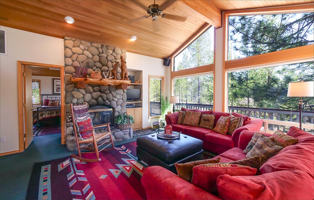 Private, upstairs master bedroom suite with direct access to the upper deck overlooking Sunriver's forested backyard.